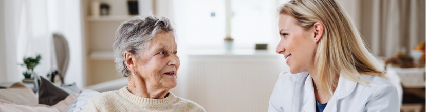 elderly woman talking to nurse