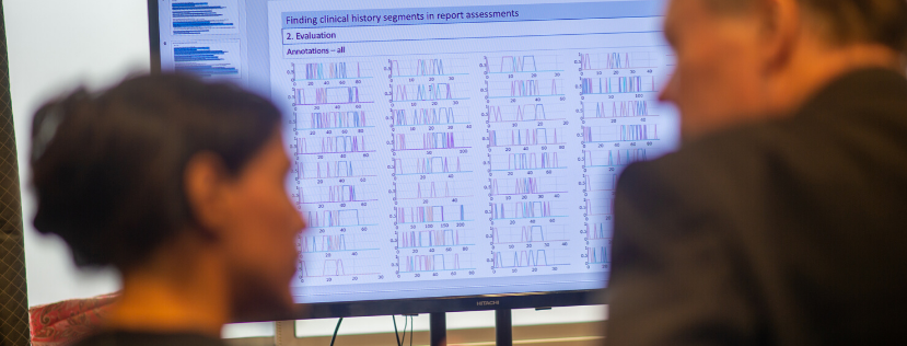 Two scientists looking a board with data