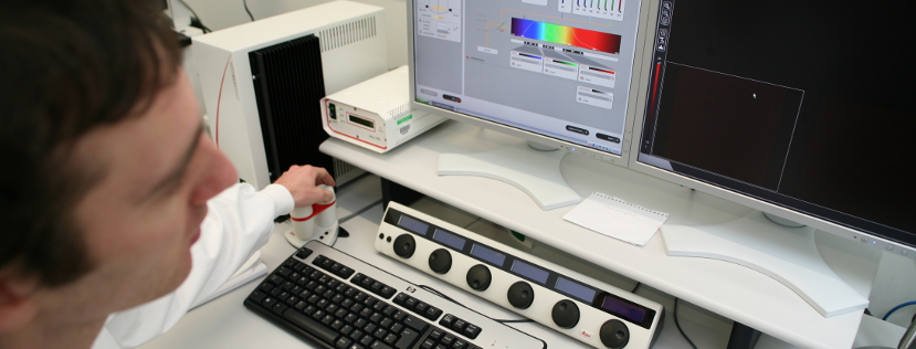 Male researcher looking at a spectroscopy result on a computer