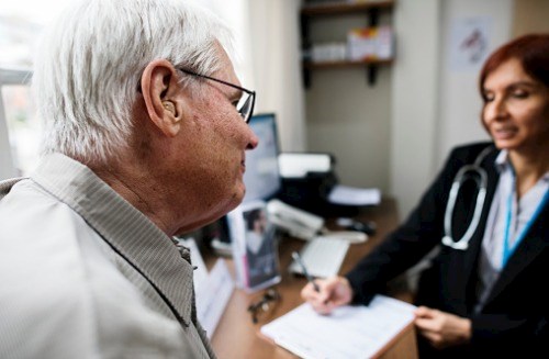 Elderly patient meeting doctor