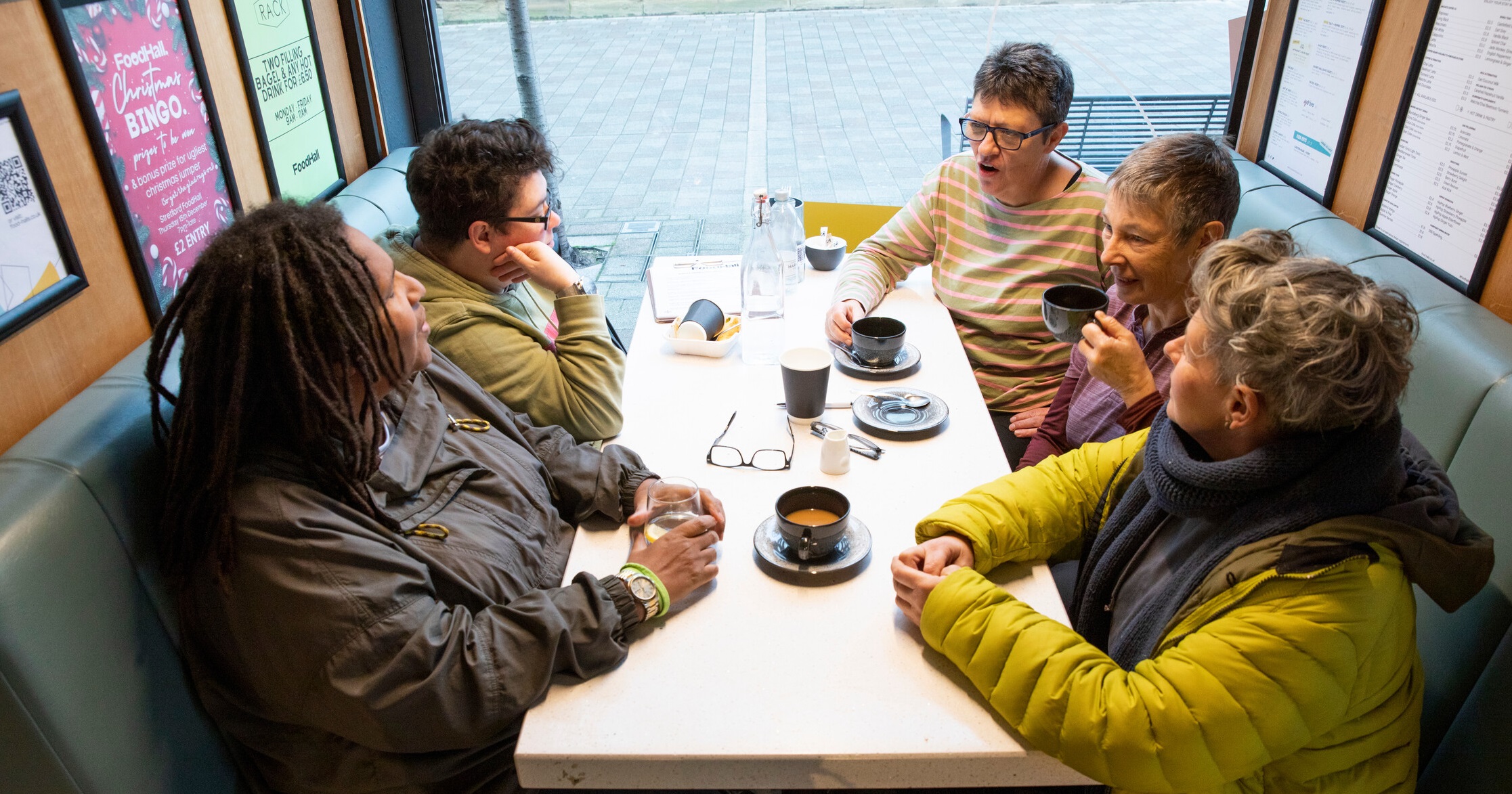 A group of people talking whilst having coffee