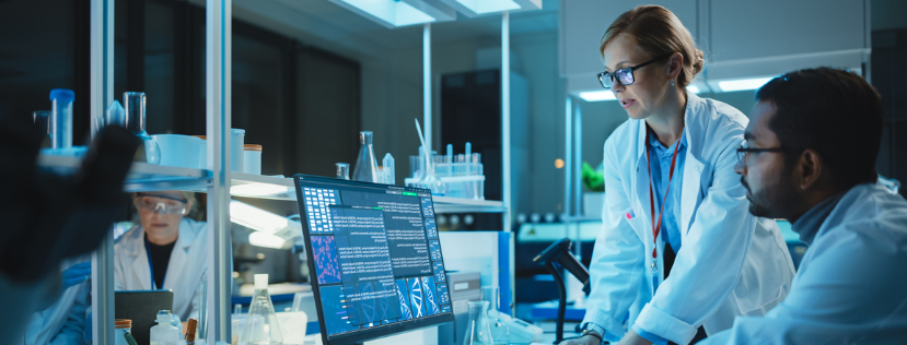 Two people in a lab looking at a computer