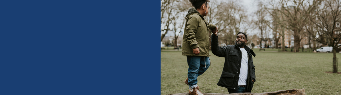 A parent and child playing in a park 