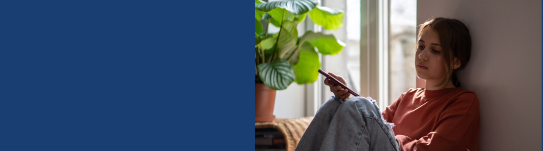 young person looking sad holding phone