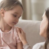 young girl with mother looking sad