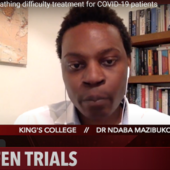 A person appears on a video call discussing COVID-19 ibuprofen trials. The background has bookshelves and a map. Text includes 