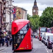 Urban scene in London with iconic red double-decker buses on a busy street