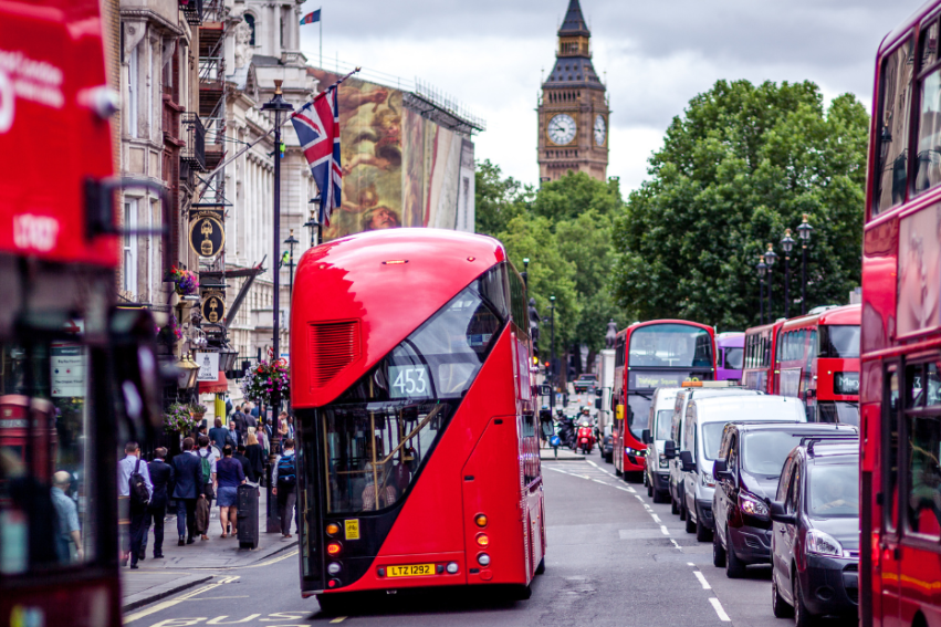 Urban scene in London with iconic red double-decker buses on a busy street