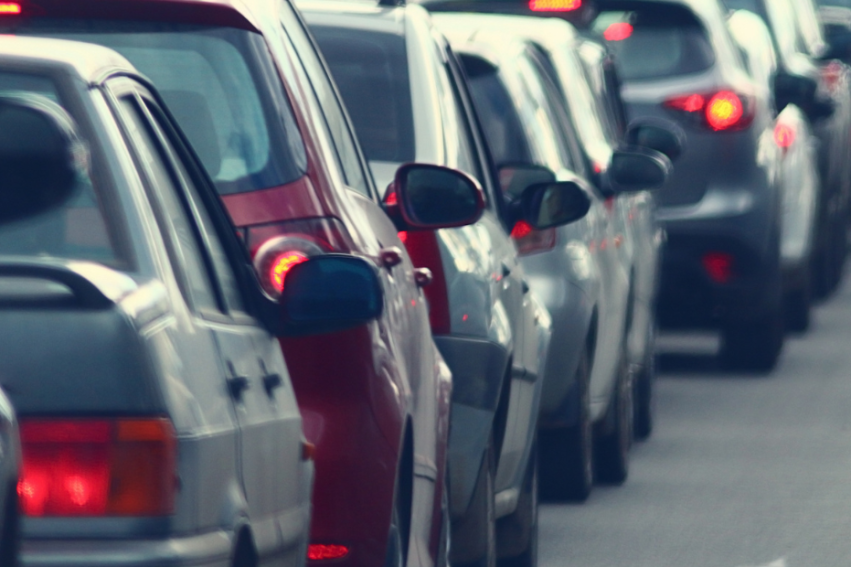 A congested urban traffic scene with a line of cars at a standstill