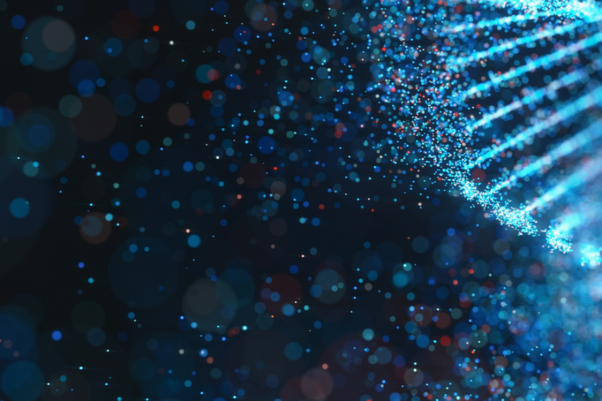 Abstract image of a glowing blue DNA double helix on a dark background with scattered multicolored particles