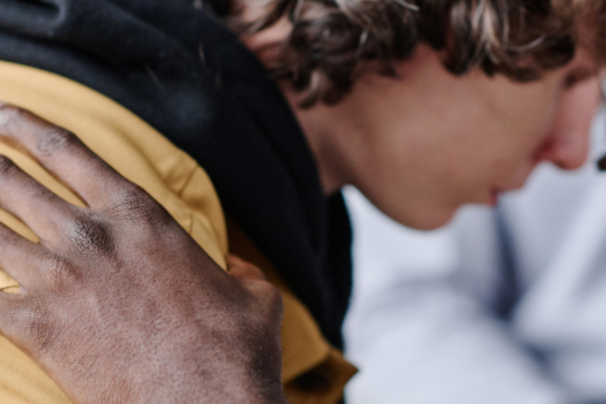 A young man being supported