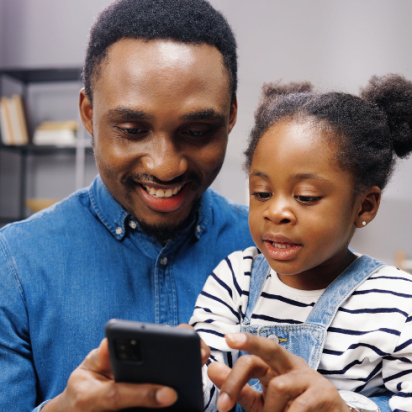 father and child looking at phone