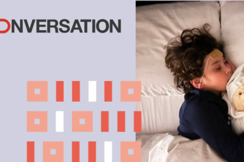 Child sleeping peacefully, wearing headbands with sensors, cuddling a teddy bear. Text on left reads 