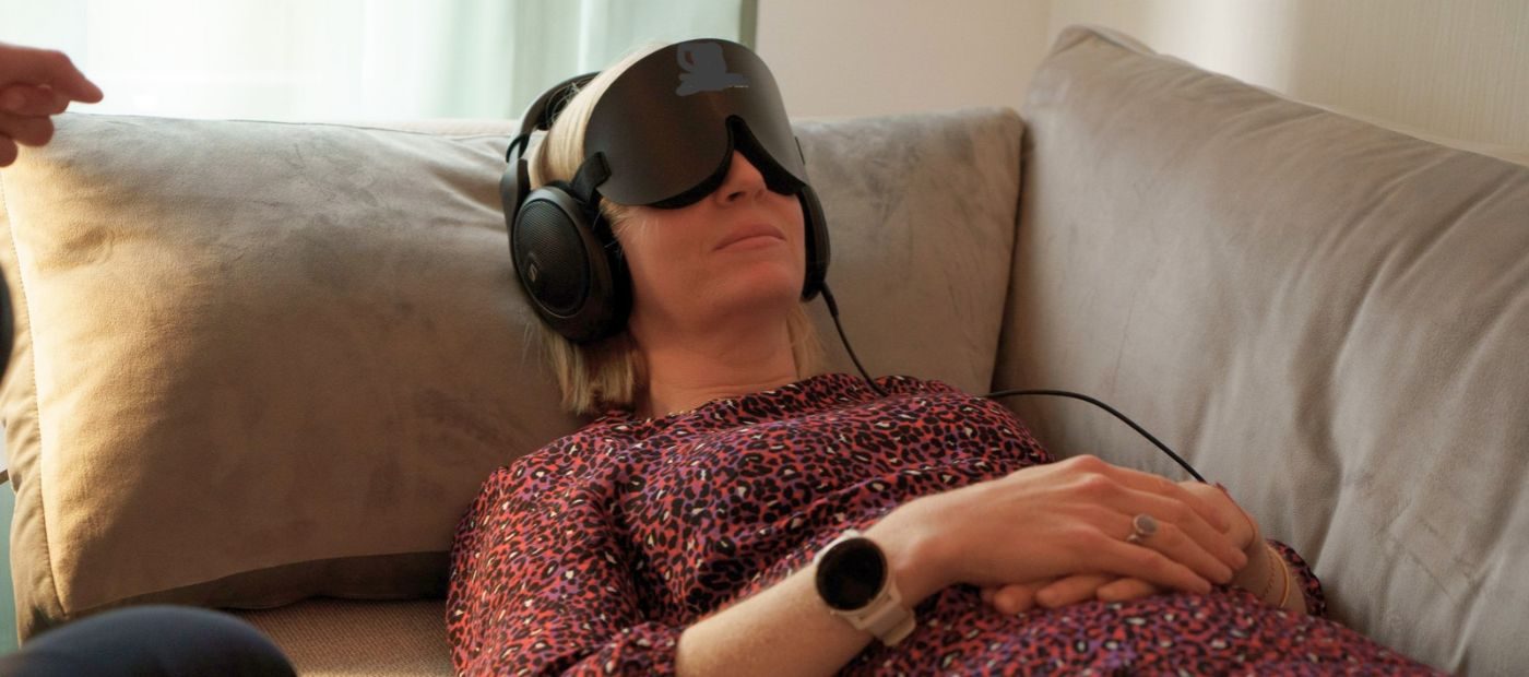 psilocybin research woman lies on couch with eye mask