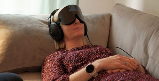 psilocybin research woman lies on couch with eye mask