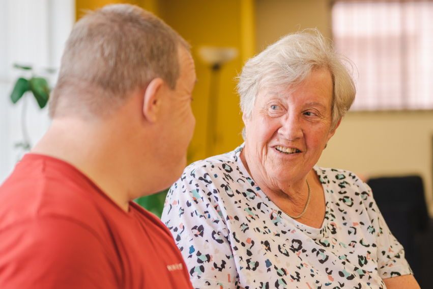 Two adults in conversation