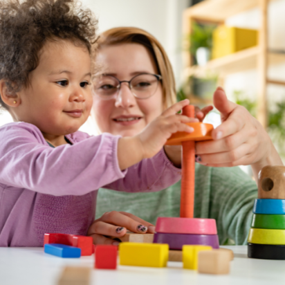 elixir baby plays with toy with mum