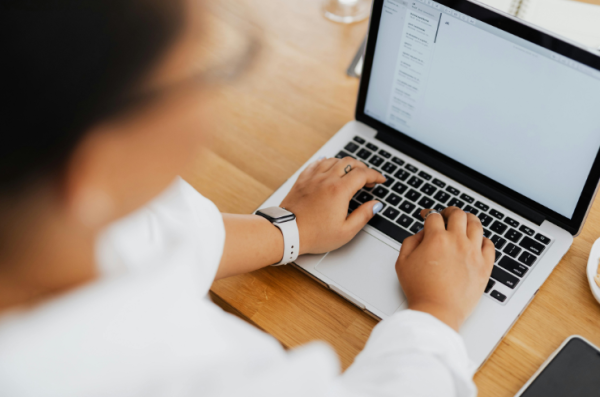 woman's hands on laptop