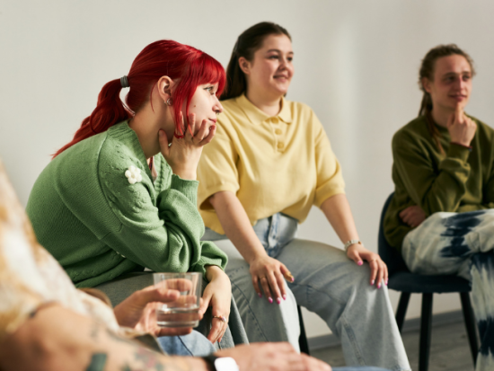 girl with red hair in a group of people