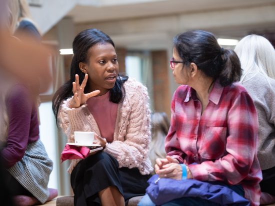 Two researchers talking over coffee