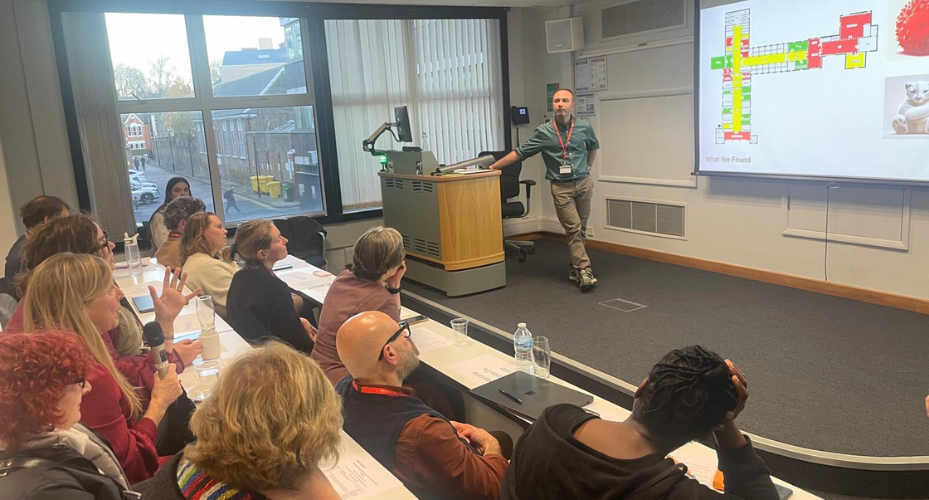 photo of one of the researchers presenting their work to an audience