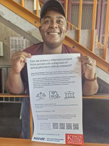 Jason Grant-Rowles holding up poster about research