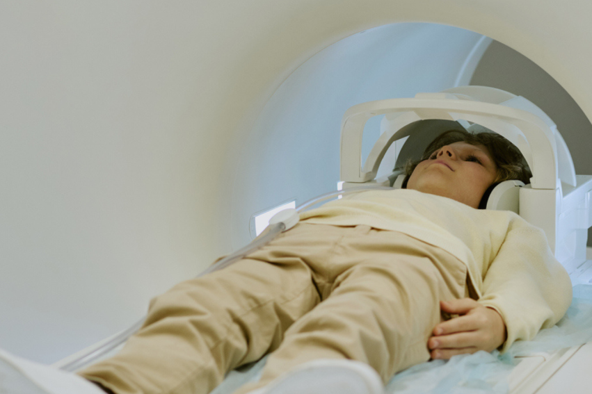 Child Lying Inside Mri Scanner Undergoing Medical Imaging Procedure
