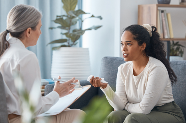 young woman sitting and talking to her psychologist during a consultation