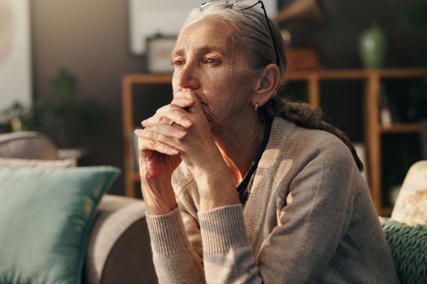 older woman looks into distance
