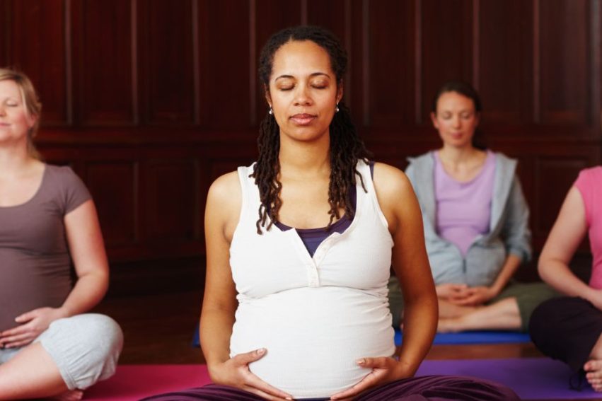 Pregnant women doing yoga
