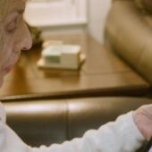 Woman looking at tablet with video playing