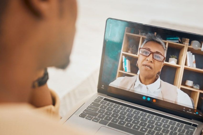 Laptop, video call and mental health with virtual counseling consultation, doctor and patient with communication
