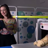 portabe scanner with baby and researcher